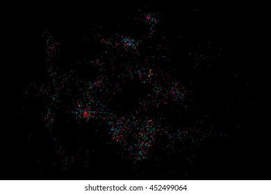 Colorful explosion of confetti. Isolated on black background. Coloured glitter and sprinkles. Grainy abstract holiday illustration. Multi colored texture.