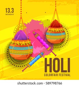 Colorful festival of holi celebration,hanging pot filled with color and decorated pichkari on colorful background.