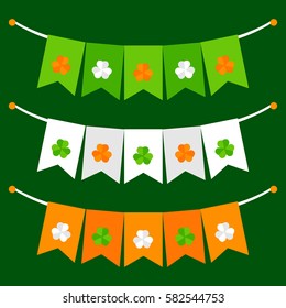 Colorful festive bunting with clover on green background