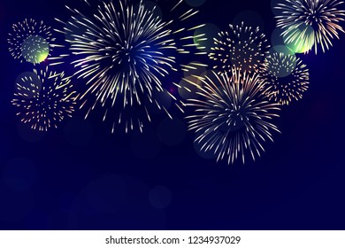 Colorful fireworks burst in the dark blue sky with glare of light for event and celebration 