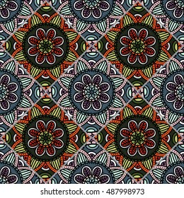 Colorful floral seamless pattern from different rhombus with mandala in patchwork boho chic style, in portuguese and moroccan motif. Hand drawn vector stock illustration