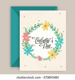 Colorful flowers decorated beautiful greeting card design with envelope for Happy Valentine's Day celebration.