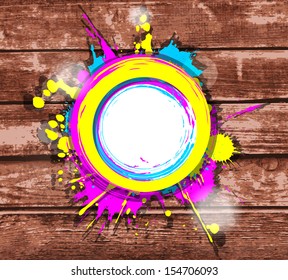 colorful frame with splashes on a brown striped wooden background