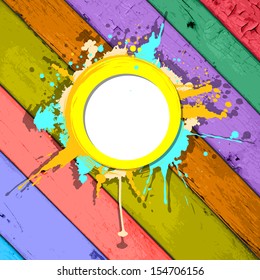 colorful grunge frame with splashes on a striped wooden background