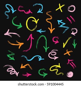 Colorful hand drawn direction arrows set on black background