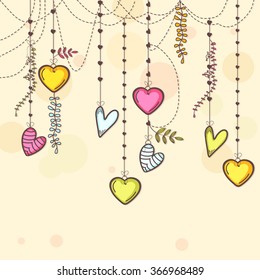 Colorful hanging hearts decorated beautiful greeting card for Happy Valentine's Day celebration.