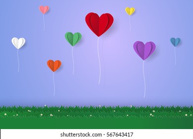 Colorful heart balloons flying over grass, paper art style