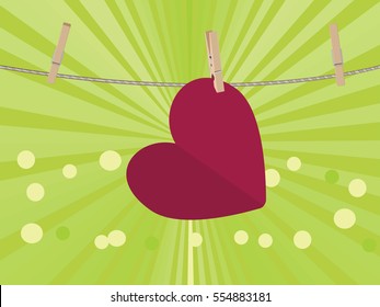 Colorful heart on a rope with wooden pegs.