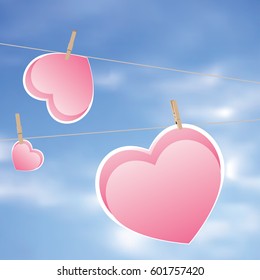 Colorful heart on a rope with wooden pegs.