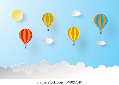 Colorful hot air balloon and sun over the cloud. paper art style.