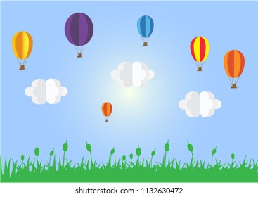 Colorful hot air balloons over green grass. Paper art style with clouds and blue sky. Vector illustration