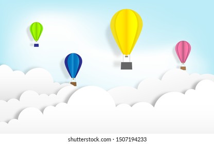 Colorful hot air balloons with white clouds on bright blue sky background in paper cut craft art style design. vector illustrat