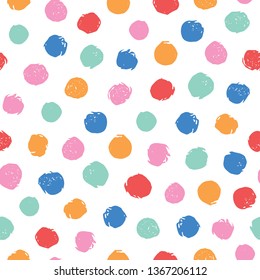 Colorful irregular polka dots vector seamless pattern. Trendy seamless pattern. Pink, yellow, orange, red, blue circles on white background. Vector illustration. Surface pattern design for fabric