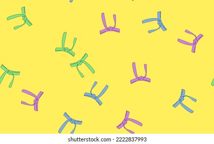 Colorful karate belts on yellow background. seamless patterns.
