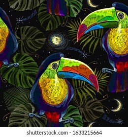 Colorful keel-billed toucan birds, moon and palm leaves seamless pattern. Embroidery art. Ramphastos sulfuratus. Jungle paradise background. Fashionable template for design of clothes, textiles 