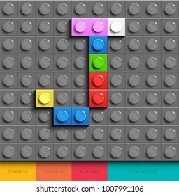 Colorful letter J from building lego bricks on gray lego background. Lego letter J