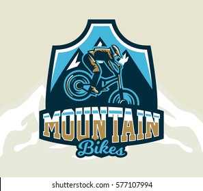 Colorful logo, emblem, label, club riders perform tricks on a mountain bike on a background of mountains, isolated vector illustration. Club downhill, freeride. Print on T-shirts.