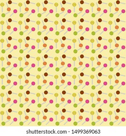 Colorful lolly pops pattern on light yellow background