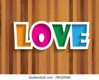 Colorful love text on wooden background.  Concept of love for valentine day.
