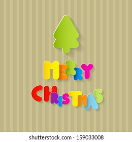 Colorful Merry Christmas Title and Tree Cut from Paper on Recycled Paper Background 