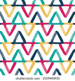 Colorful overlapping triangles seamless vector pattern. Geometric zigzag kids background white, pink, blue, yellow, teal. Hand drawn doodle triangles in horizontal rows repeating backdrop. Kids fabric
