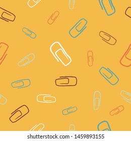 Colorful paper clips seamless pattern. Color clips on yellow background.