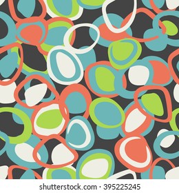 Colorful pattern in blue, orange and green colors. Seamless texture with rings and ovals on black background. Stylish and abstract