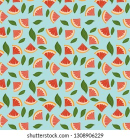 Colorful pattern made of slices of citrus fruits orange, lemon, lime, grapefruit and green leaves.