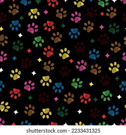 
Colorful paw prints with stars seamless fabric design pattern with dark background