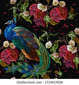 Colorful peacocks, red pomegranate fruit and white flowers. Tropical seamless pattern. Exotic birds. Fashionable template for design of clothes, textile 