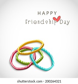 Colorful pearl bangles on grey background for Happy Friendship Day celebrations.