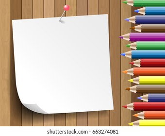 Colorful pencil with paper note  on wooden background
