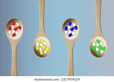Colorful pills-capsules of medicines, vitamins or supplements in wooden kitchen spoons on a blue background. Concept of medicine and health