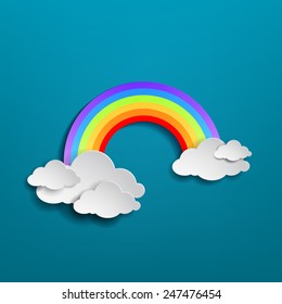 Colorful rainbow arch with clouds on blue background.