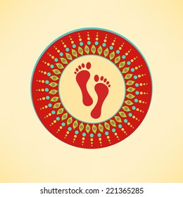 Colorful rangoli with Goddess Laxmi's footprint for Diwali celebration on shiny yellow background.