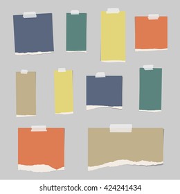 Colorful ripped blank note paper are stuck on gray background