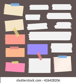 Colorful ripped lined blank note paper, sticky, adhesive tapes are stuck on brown wall