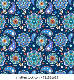 Colorful seamless pattern. Beautiful floral motif. Background in oriental style. The template for printing on fabric. Texture with mandalas on dark blue.