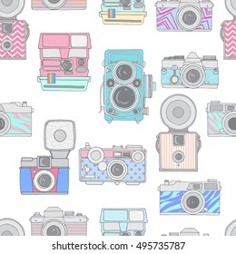 Colorful seamless pattern with cute retro cameras. Hand drawn vintage photocameras. Vector illustration.