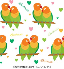 Colorful seamless pattern with lovebirds. Repeating background with tropical birds and hearts.