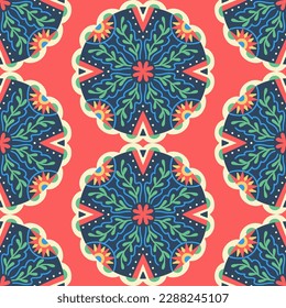 Colorful seamless pattern with Mandala. Round symmetrical decorative ornament of abstract flowers, plants and geometric elements in the form of triangles. Mexican folk style. Green and red colors