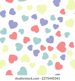Colorful seamless pattern of pastel red, yellow and blue hearts. Suitable for printing on textile, fabric, wallpapers, postcards, wrappers