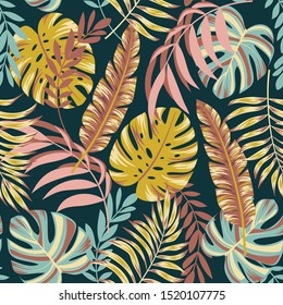 Colorful seamless pattern with tropical leaves on dark background. Floral seamless vector tropical pattern background with exotic leaves, jungle leaf. Trendy summer Hawaii print.