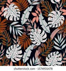 Colorful seamless pattern with tropical plants on dark background. Jungle leaves. Floral pattern. Vector background for various surface. Exotic wallpaper. Trendy summer print.