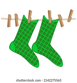 Colorful socks hanging on rope isolated on white background.Green checkered socks on clothesline.Cotton or wool children sock dry and hang on laundry string with clothespins.Laundry drying icon.Vector