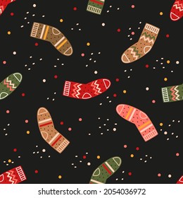 Colorful socks on a black background. Vector seamless pattern