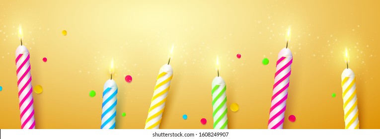 Colorful sparkling candles on orange background. Birthday, anniversary or celebration template.