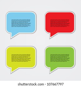 Colorful Speech Bubble Grid – Blue, Red, Yellow, and Green Dialog Icons with Placeholder Text on Light Background. A vibrant set of four speech bubbles arranged in a 2×2 grid on a light gray background. Each bubble features a distinct color—blue, red, yellow, and green—with white borders and downward-pointing tails, simulating dialogue. The bubbles contain placeholder text in black font, representing commentary or communication. Ideal for use in presentations, infographics, educational materials, social media visuals, or branding assets. The clean layout and bold colors make it suitable for highlighting multiple perspectives or organizing information in a visually engaging way.