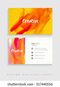 Colorful splash decorated, creative horizontal business card, name card or visiting card set on grey background.