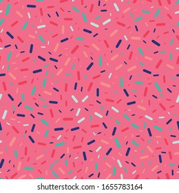 Colorful sprinkles on pink background seamless repeat vector pattern for wrapping paper, prints, fabrics.